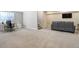 Finished basement with an office space, carpeted stairs, and wall-mounted TV at 16277 Talons Bluff Ln, Monument, CO 80132