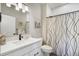 Well-lit bathroom featuring modern fixtures, a shower with elegant curtain, and clean design at 16277 Talons Bluff Ln, Monument, CO 80132