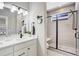 Bathroom featuring tiled shower, frameless glass door, and modern fixtures at 16277 Talons Bluff Ln, Monument, CO 80132