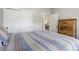 Cozy bedroom featuring sliding door closet, hard surface floors and rustic furniture at 16277 Talons Bluff Ln, Monument, CO 80132