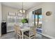 Bright dining area with modern lighting and access to outdoor space via sliding door at 16277 Talons Bluff Ln, Monument, CO 80132