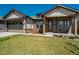 Charming single-Gathering home featuring stone accents, well-manicured lawn, and inviting front porch at 16277 Talons Bluff Ln, Monument, CO 80132