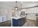 Stylish kitchen with a dark blue island, white countertops, and stainless steel appliances at 16277 Talons Bluff Ln, Monument, CO 80132
