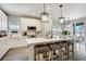 Bright and airy kitchen showcasing a large island with seating and modern design elements at 16277 Talons Bluff Ln, Monument, CO 80132