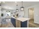 Open kitchen featuring an island with pendant lights and stainless steel dishwasher at 16277 Talons Bluff Ln, Monument, CO 80132