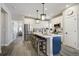 Modern kitchen featuring an island with seating, stainless steel appliances, and white cabinetry at 16277 Talons Bluff Ln, Monument, CO 80132