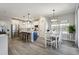 Bright and open kitchen with island seating, modern appliances, and adjacent dining area at 16277 Talons Bluff Ln, Monument, CO 80132