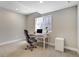 A basement office with a modern desk, chair, and natural light at 16277 Talons Bluff Ln, Monument, CO 80132