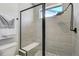 Tiled shower with frameless glass door, rain shower head and built in bench at 16277 Talons Bluff Ln, Monument, CO 80132