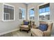 Cozy sitting area with two comfortable armchairs and ample natural light from windows at 16277 Talons Bluff Ln, Monument, CO 80132