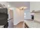 Beautiful open kitchen with granite countertops and stainless steel refrigerator at 909 S Dawson Way # 2, Aurora, CO 80012