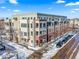 Aerial view of a modern apartment building in a snowy neighborhood at 4383 Tennyson St # 1A, Denver, CO 80212