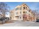 Exterior view of a brick apartment building with street parking at 4383 Tennyson St # 1A, Denver, CO 80212