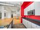 Modern kitchen with wood countertops and red accent wall at 4383 Tennyson St # 1A, Denver, CO 80212