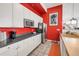 White kitchen cabinets and red walls, great for a small office at 4383 Tennyson St # 1A, Denver, CO 80212