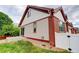 Side view of house with red and beige siding, and small lawn at 11131 Bryant Mews, Westminster, CO 80234