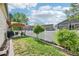 Well-maintained backyard with a manicured lawn, white picket fence and shaded pergola area at 2420 E 127Th Ave, Thornton, CO 80241