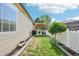 Landscaped backyard with a walkway to a cozy covered patio at 2420 E 127Th Ave, Thornton, CO 80241
