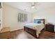 Comfortable bedroom features a ceiling fan, window with blinds and hardwood floors at 2420 E 127Th Ave, Thornton, CO 80241