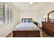 Comfortable bedroom with stylish furnishings including a wooden bed frame and dresser at 2420 E 127Th Ave, Thornton, CO 80241