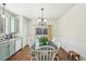 Open Dining Area with a chandelier, table with seating, and a view of the backyard through a sliding glass door at 2420 E 127Th Ave, Thornton, CO 80241