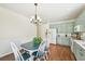 Open floor plan showcasing the kitchen's layout and nearby dining room table and chairs at 2420 E 127Th Ave, Thornton, CO 80241