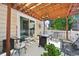Cozy covered patio with ample seating and a view of the white-fenced yard at 2420 E 127Th Ave, Thornton, CO 80241