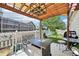 Covered patio featuring a fire pit, seating, and a view of the fenced yard at 2420 E 127Th Ave, Thornton, CO 80241