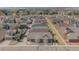 Aerial view showcases a neighborhood with varied home styles and mature trees at 869 Bluestem Ln, Louisville, CO 80027