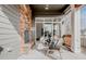 Relaxing outdoor balcony with a stone fireplace and comfortable seating area at 869 Bluestem Ln, Louisville, CO 80027