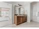 Bathroom vanity with a marble countertop and a mirror in a bright, updated primary bathroom at 869 Bluestem Ln, Louisville, CO 80027