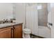 Cozy bathroom featuring dark-stained cabinets, a combination tub and shower, and neutral wall colors at 869 Bluestem Ln, Louisville, CO 80027