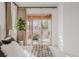 Bright bedroom featuring a sliding glass door, neutral colors, and a cozy seating area on the patio at 869 Bluestem Ln, Louisville, CO 80027