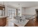 Elegant dining area with a glass table, upholstered chairs, and modern lighting fixtures at 869 Bluestem Ln, Louisville, CO 80027