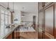 Kitchen and dining area with dark wood cabinets, granite countertops, and elegant lighting fixtures at 869 Bluestem Ln, Louisville, CO 80027