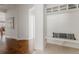 Hallway with a tile entryway, wood floors, and a built-in shelf and coat rack at 869 Bluestem Ln, Louisville, CO 80027
