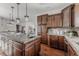 Well-lit kitchen featuring granite countertops, a large island, and dark wood cabinets at 869 Bluestem Ln, Louisville, CO 80027