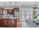 Open kitchen and dining area with stainless steel appliances, dark wood cabinets, and a modern table at 869 Bluestem Ln, Louisville, CO 80027