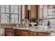Kitchen with granite countertops, a stainless steel faucet, and dark wood cabinets and hardware at 869 Bluestem Ln, Louisville, CO 80027