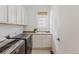 Bright laundry room featuring white cabinets, a sink, and a side-by-side washer and dryer at 869 Bluestem Ln, Louisville, CO 80027