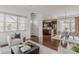 Open-concept living room with hardwood floors flows into the dining area and kitchen at 869 Bluestem Ln, Louisville, CO 80027