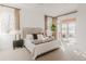 Beautiful main bedroom with a sitting area and a sliding door to the balcony at 869 Bluestem Ln, Louisville, CO 80027
