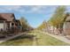 Street view of homes lining the center median green space on a sunny day at 869 Bluestem Ln, Louisville, CO 80027