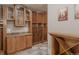 Custom wine cellar featuring wooden racks, granite countertop and glass cabinets for elegant storage at 869 Bluestem Ln, Louisville, CO 80027