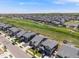 Aerial view of a neighborhood close to a golf course with well-maintained lawns and mature trees at 16448 E 111Th Pl, Commerce City, CO 80022