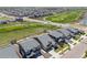 Aerial view showcasing modern homes near a golf course, with well-maintained lawns and outdoor spaces at 16448 E 111Th Pl, Commerce City, CO 80022