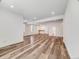 Finished basement featuring durable vinyl plank flooring, neutral wall paint, and a small wet bar at 16448 E 111Th Pl, Commerce City, CO 80022