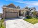 Inviting single Gathering home showcasing stone accents, a spacious driveway, and manicured lawn at 16448 E 111Th Pl, Commerce City, CO 80022