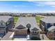 Two-story home with stone accents, a well-manicured lawn, and mature landscaping at 16448 E 111Th Pl, Commerce City, CO 80022