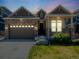 Charming home exterior with a stone facade, covered porch, and well-manicured lawn, offering curb appeal at 16448 E 111Th Pl, Commerce City, CO 80022